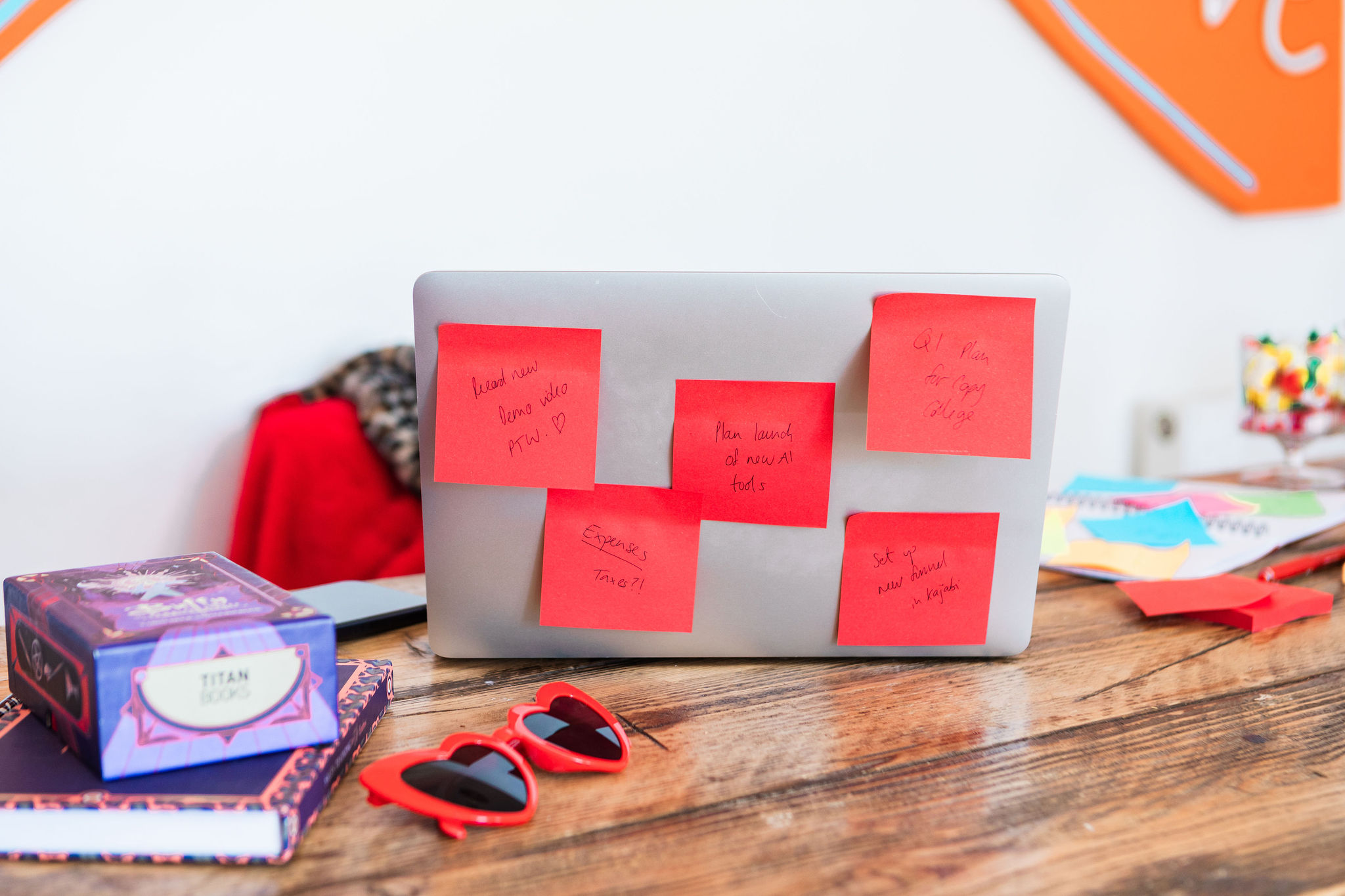 A laptop covered in handwritten red sticky notes